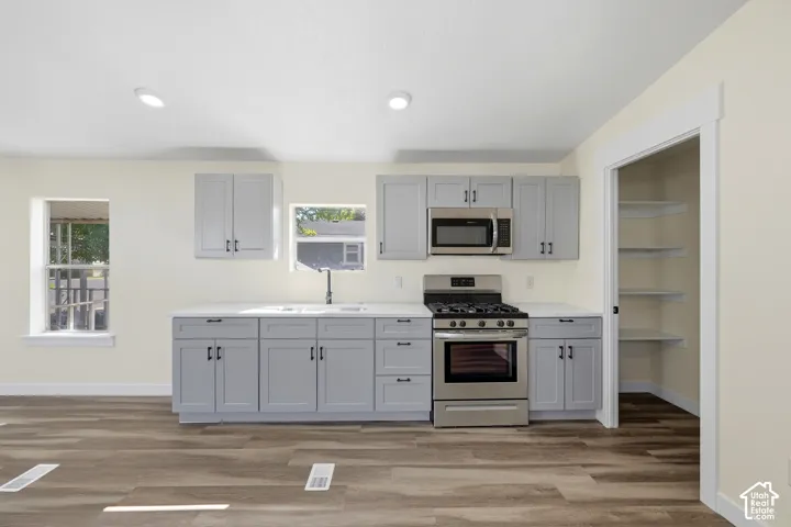 Kitchen featuring wood-finish flooring, recessed lighting, and light-toned cabinetry