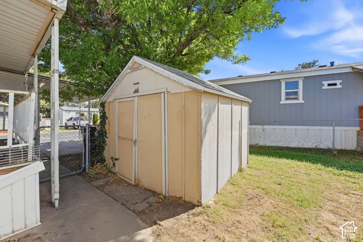 Utility shed with exterior panel siding and a gabled roof