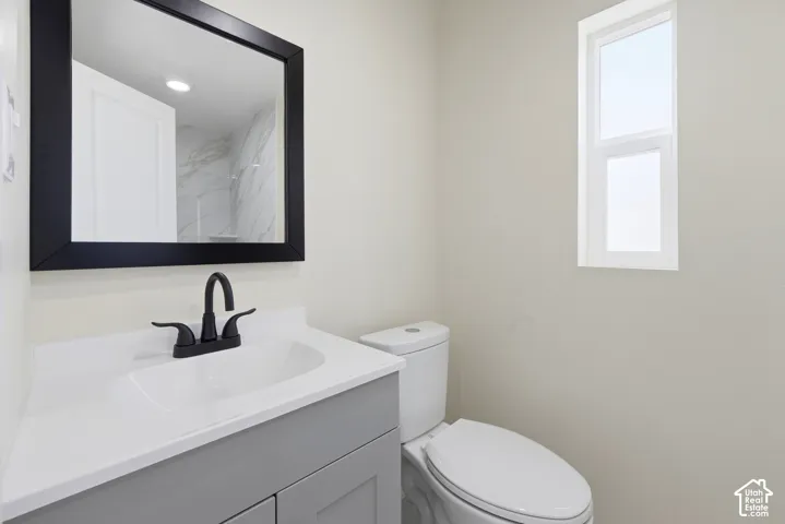 Vanity with integrated sink, matte black faucet, and framed mirror