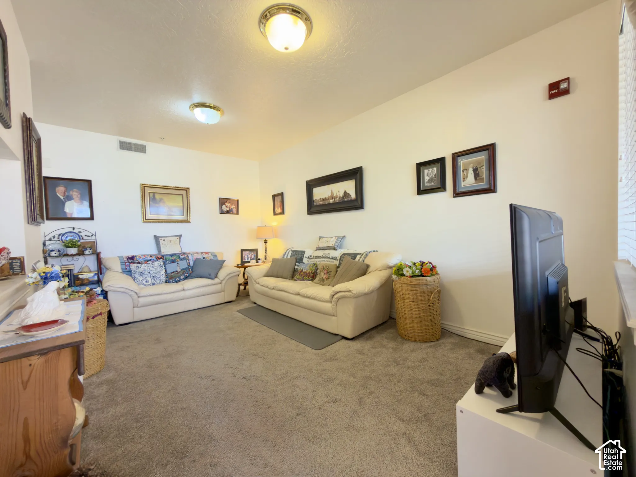 Large living room with large window featuring lots of natural light