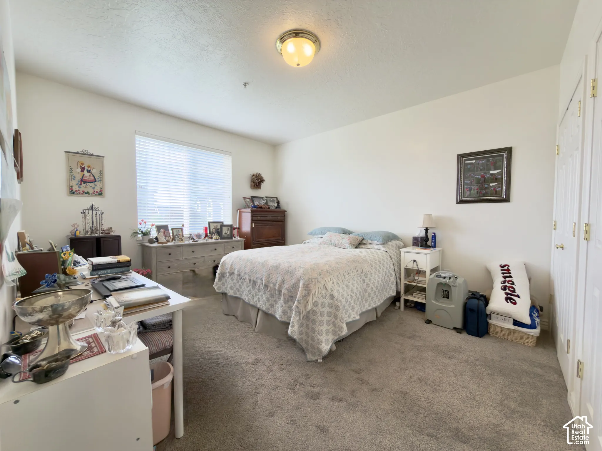 Large bedroom with a large window and double closets