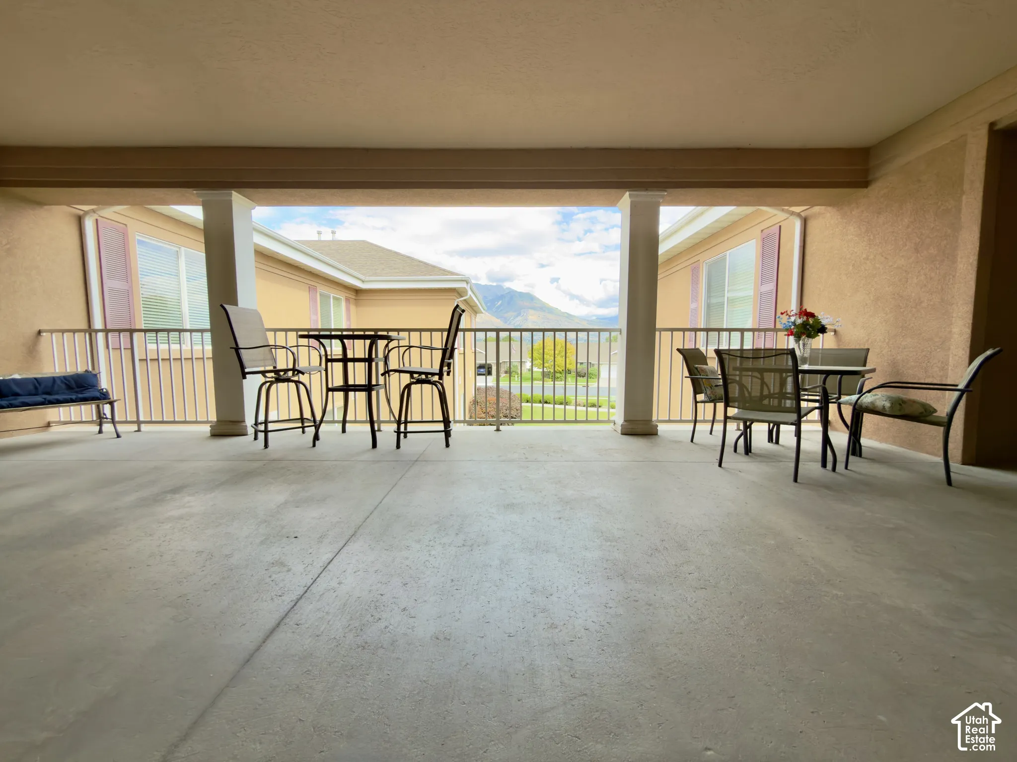 Large covered patio right outside front door with furniture & mountain views