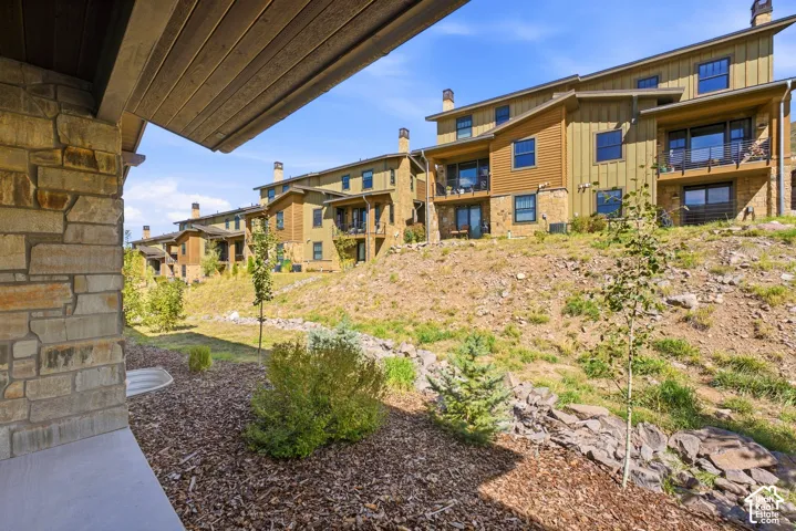 Stone veneer exterior with wood paneling and multiple balconies