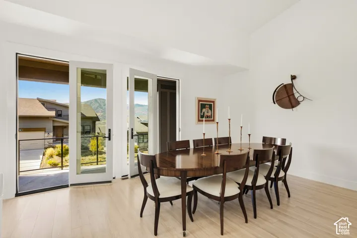 Light wood-finish flooring, white walls, and a high vaulted ceiling