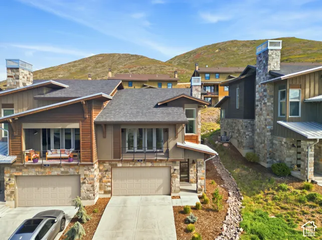Stone veneer and wood siding exterior with multiple balconies