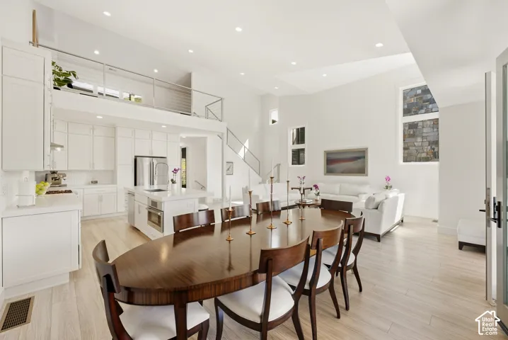 Loft-style architecture with an open-concept kitchen, dining, and living area