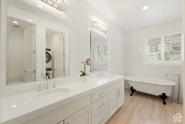 Dual sink vanity with white countertop, white cabinetry, and polished chrome fixtures
