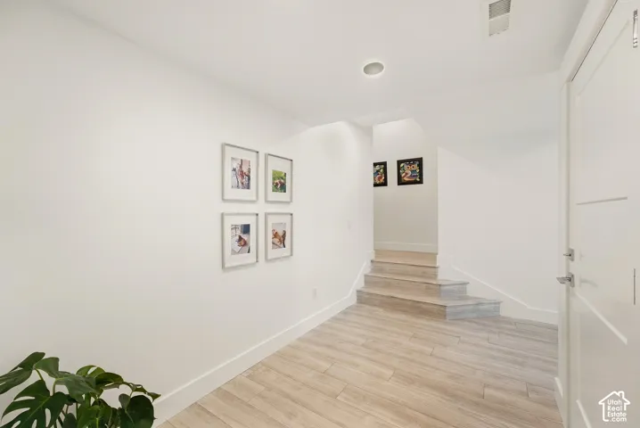 Light wood-finish flooring with a multi-level staircase
