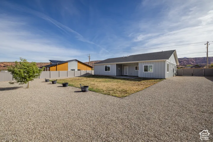 Light gray exterior siding and a dark shingle roof