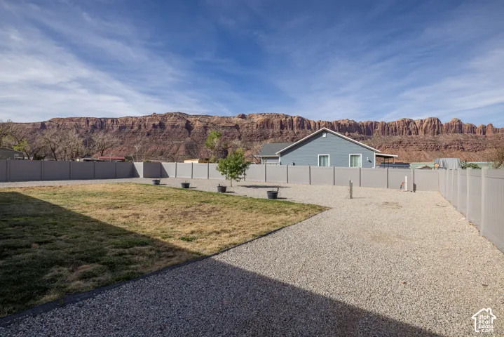 Expansive backyard featuring a partial grass area and a large gravel area