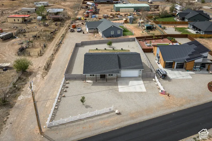 Single-story residence featuring a two-car garage, covered porch, and gravel landscaping
