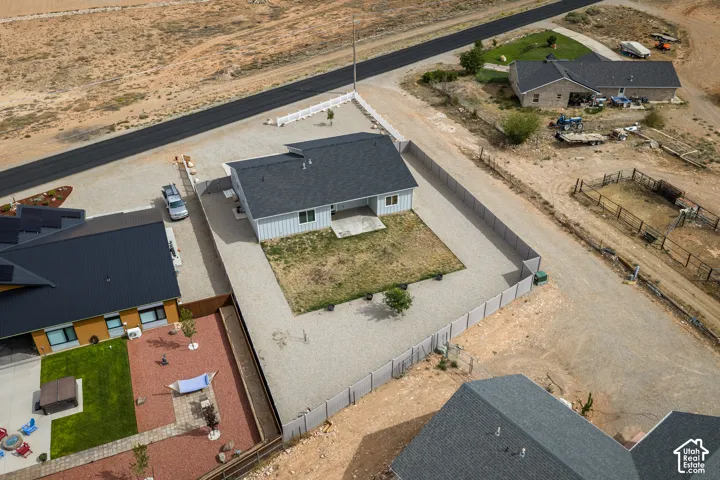 Single-story residence with light gray siding and a dark shingle roof