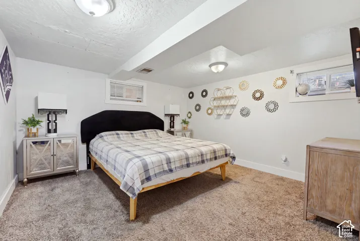 Wall-to-wall carpeting with white baseboards, recessed ceiling lighting, and a window with horizontal blinds