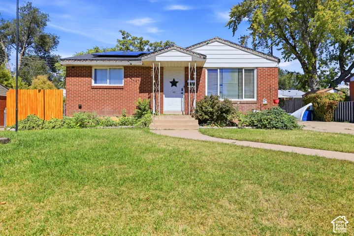Brick exterior with white siding accents and solar panels