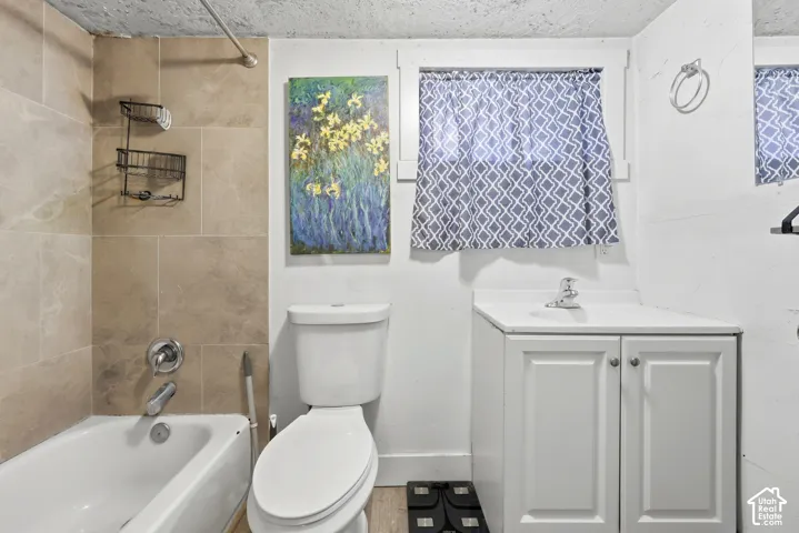 Bathroom featuring a white vanity with panel cabinetry, a white basin, and a chrome faucet