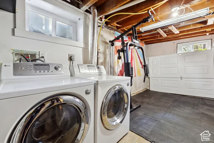 Utility space with exposed beam ceiling, recessed lighting, and a utility window