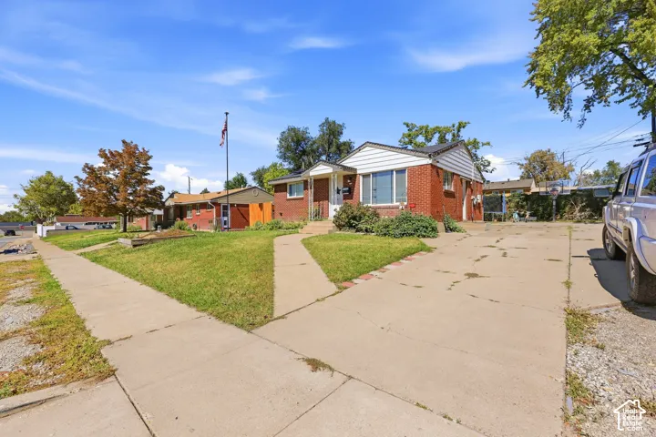 Brick exterior with white siding accents and a concrete driveway