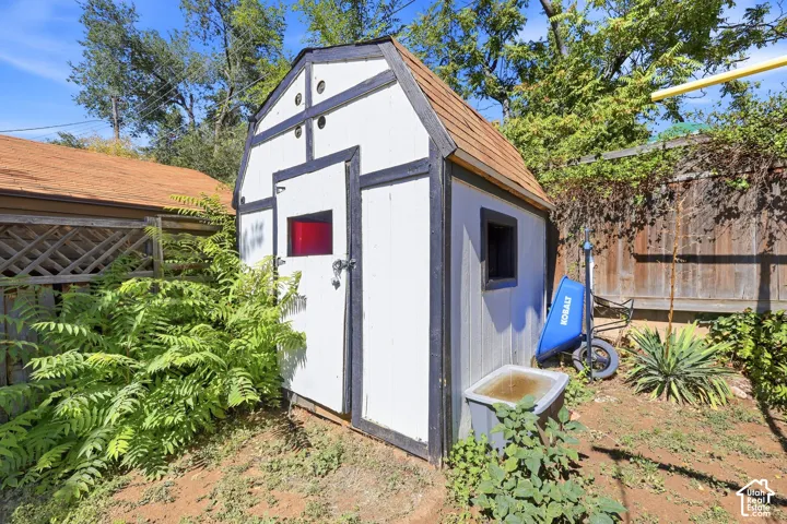 Gable roof shed featuring a single entry door and a side window