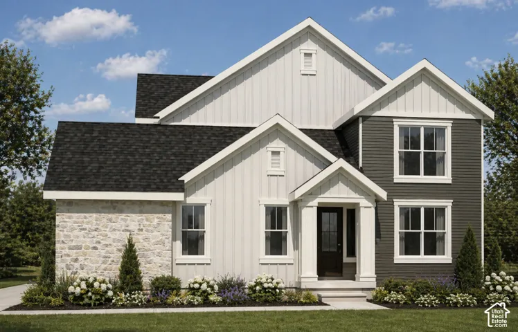 Contemporary exterior with multi-toned siding, stone veneer accents, and a dark shingle roof