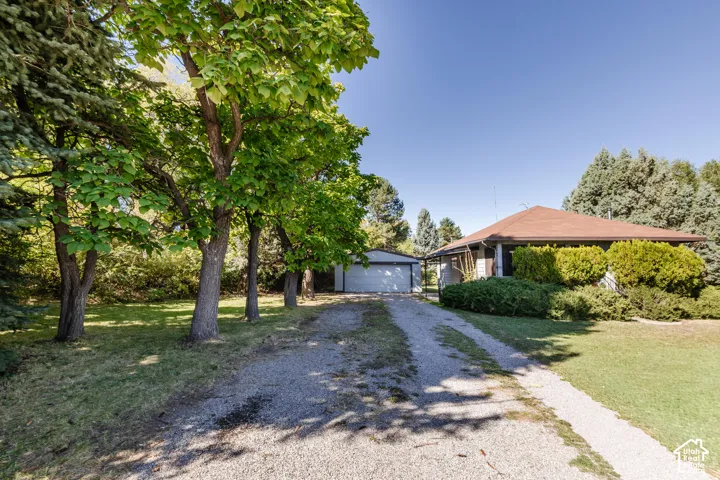 Gravel driveway extending to a detached garage