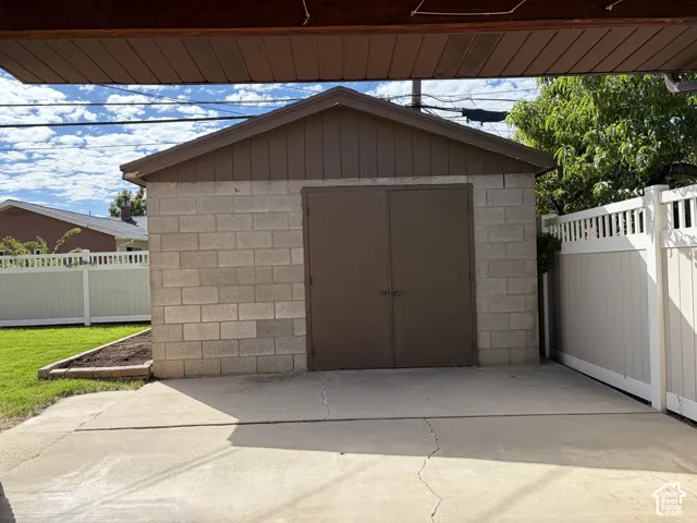 Detached workshop/shed with electricity, concrete block walls, and double entry doors on an approximately 300 sq ft concrete pad