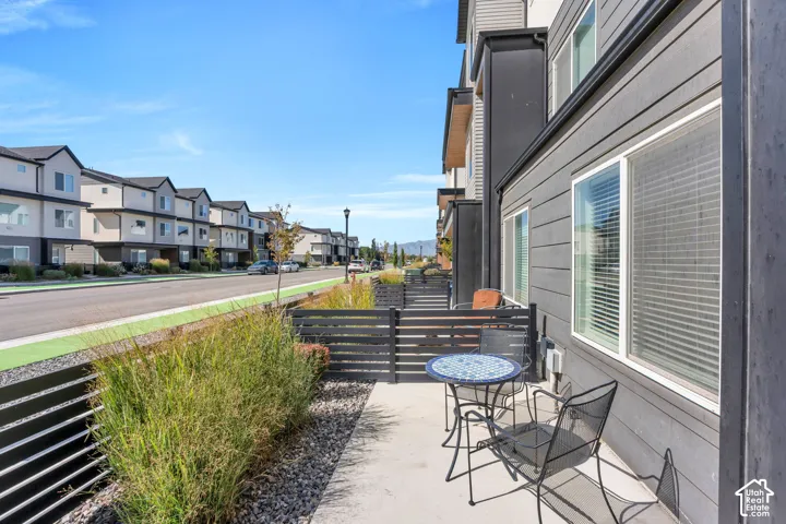 Concrete patio space with a slatted privacy fence