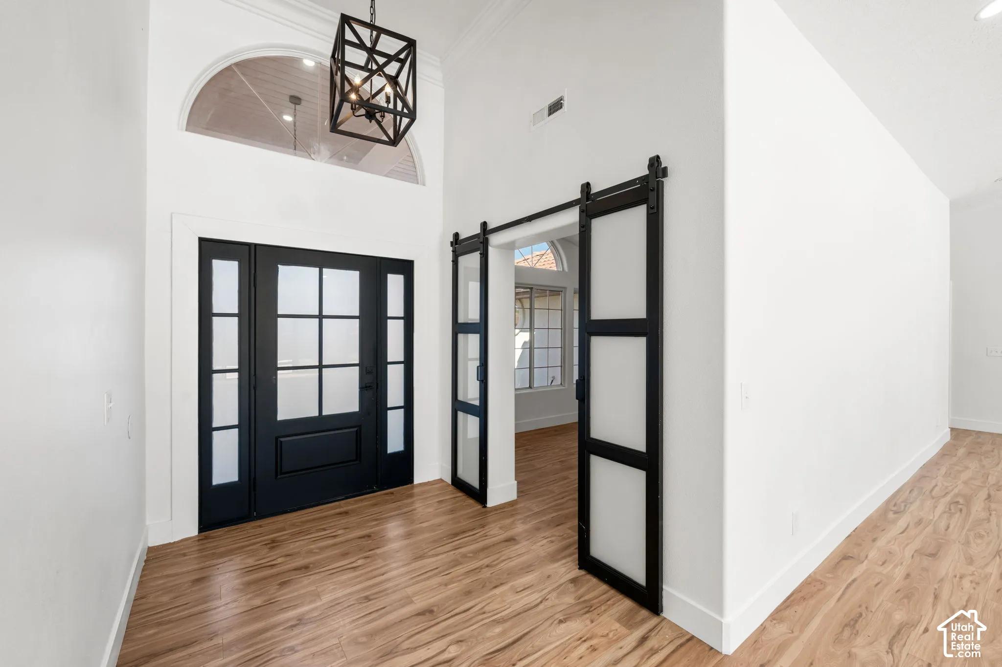 Vaulted entry with wood-finish flooring