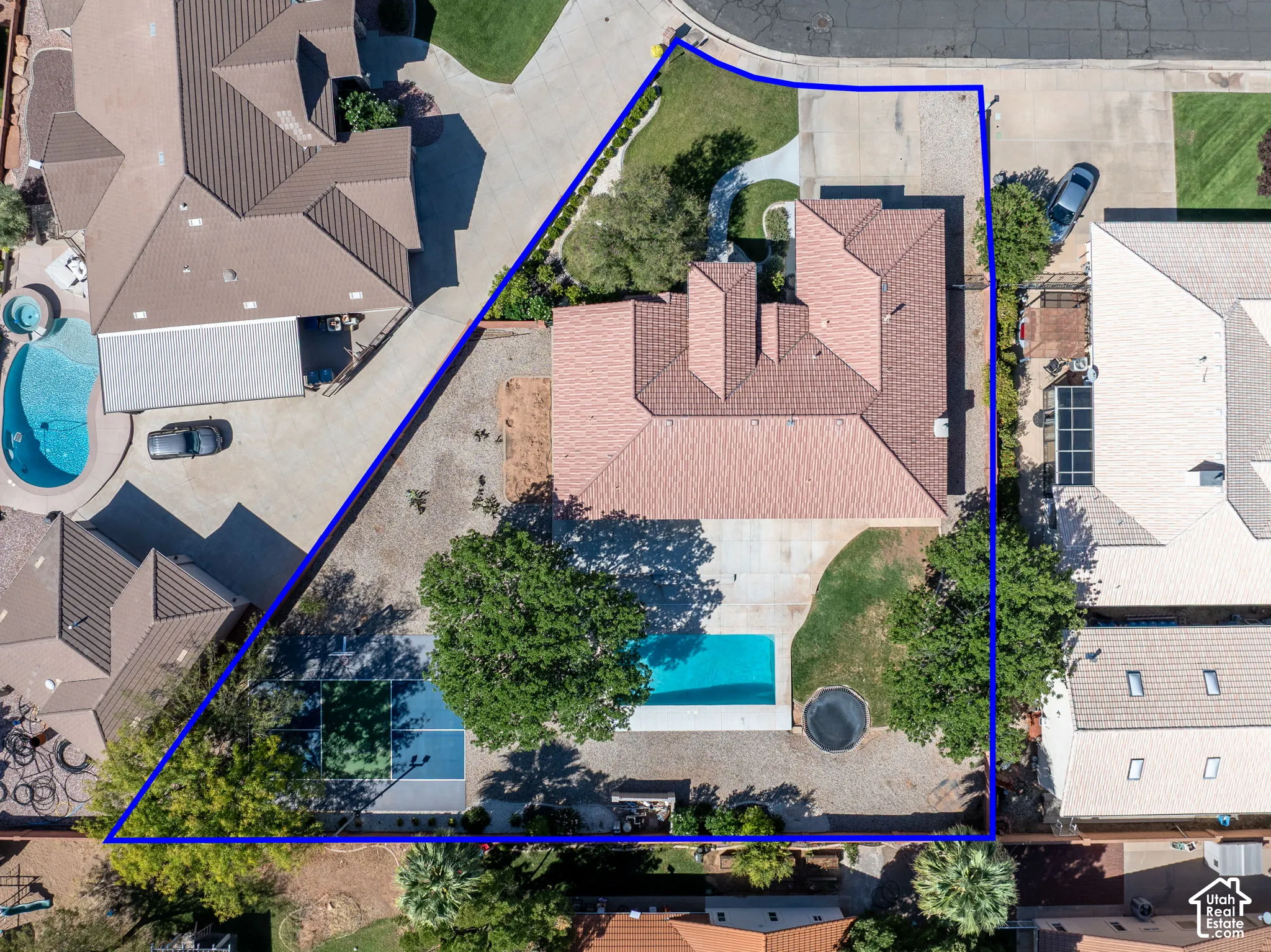 Property with a swimming pool, adjacent sport court, and a trampoline