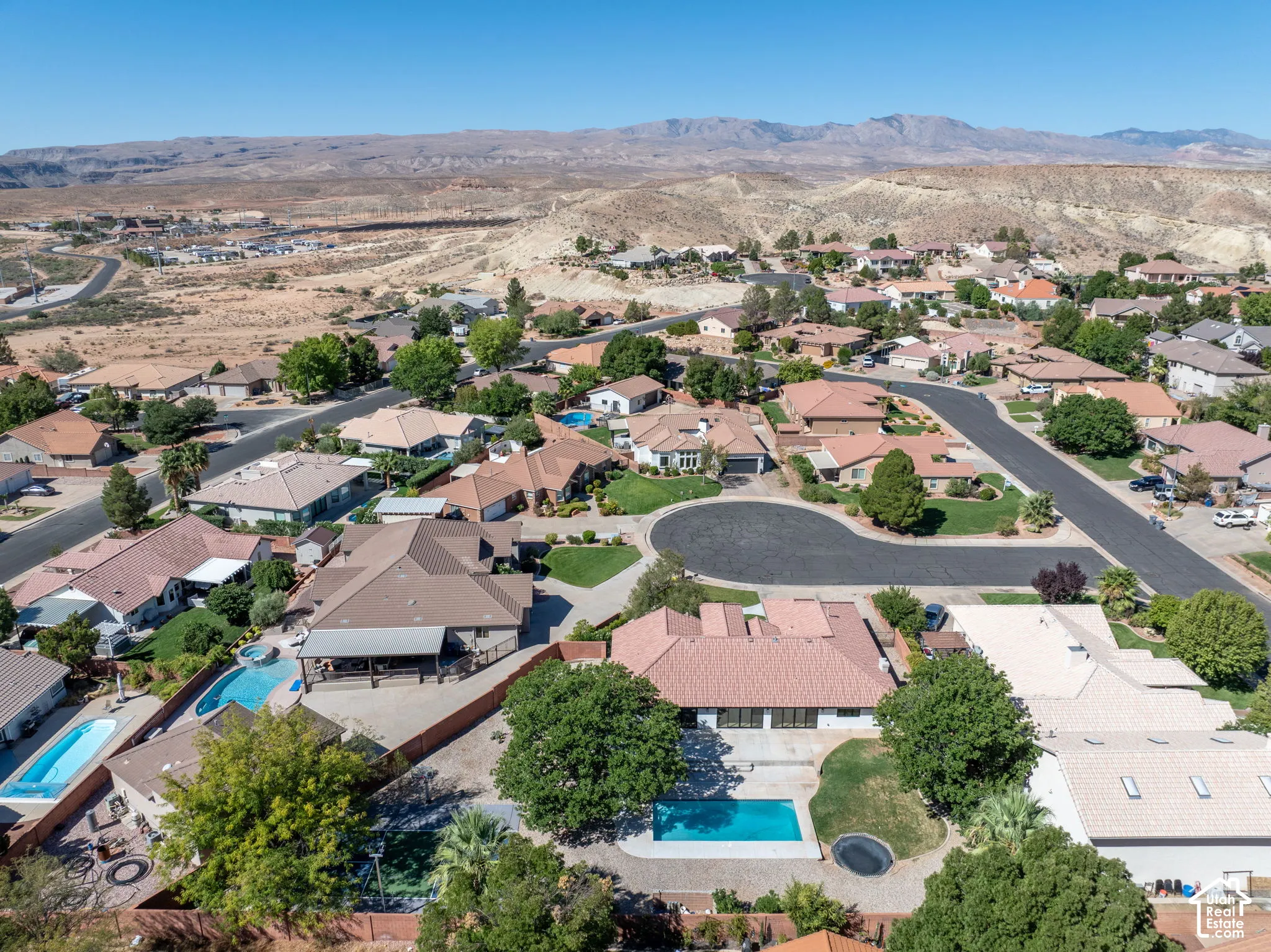 Residential neighborhood featuring single-story homes with varied rooflines and a clear mountain backdrop