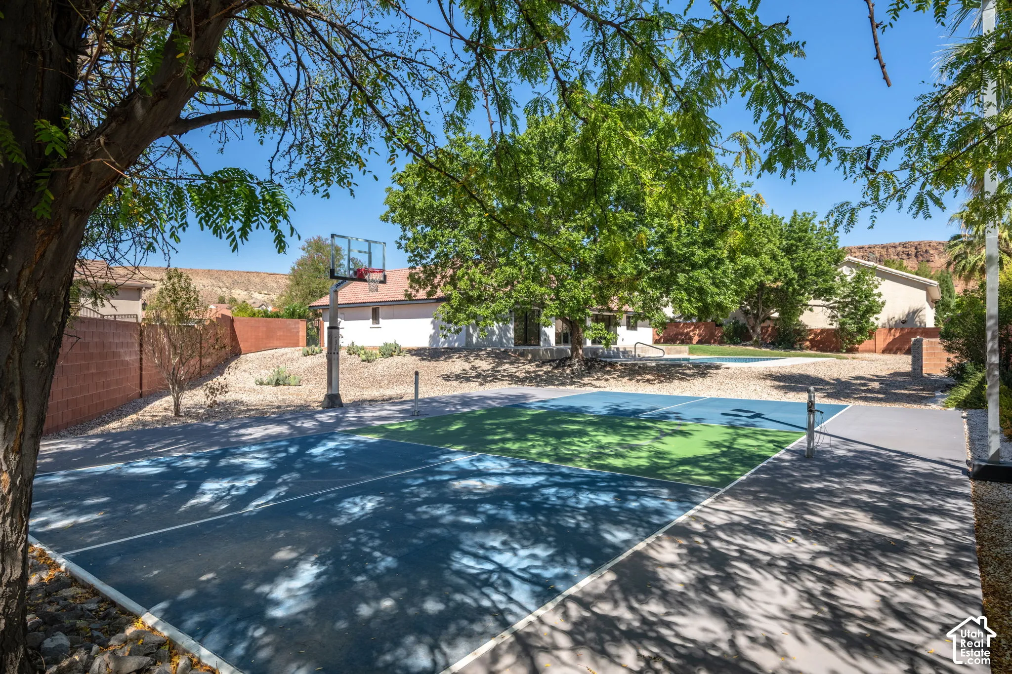 Multi-sport court featuring dedicated basketball and tennis areas