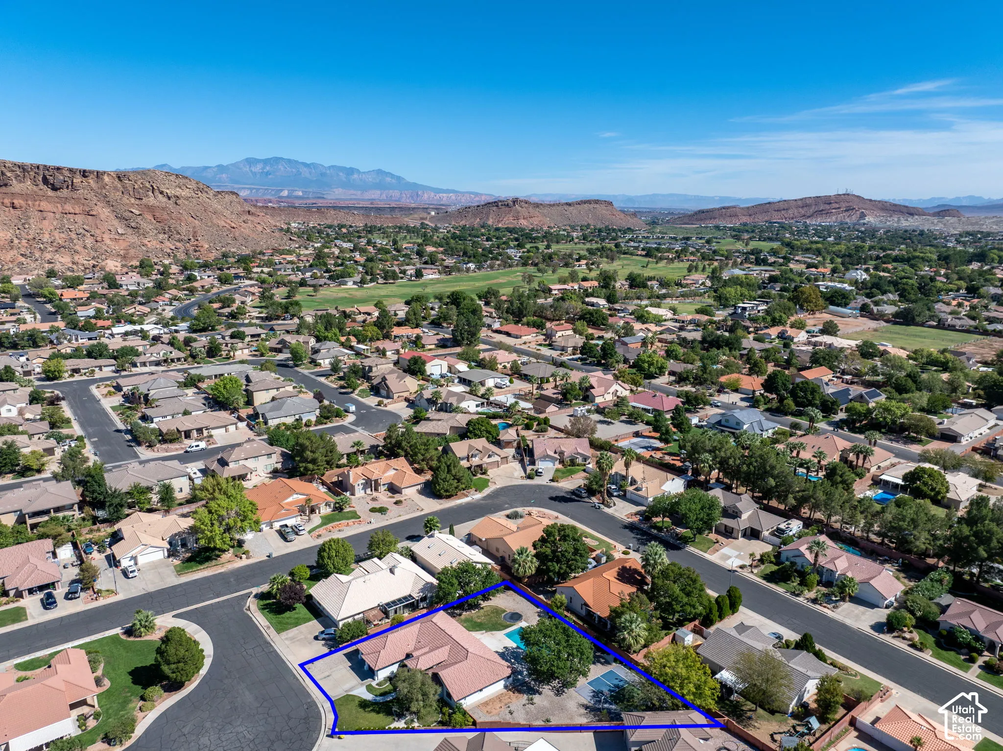 Aerial perspective showcasing a residential neighborhood with mountain scenery