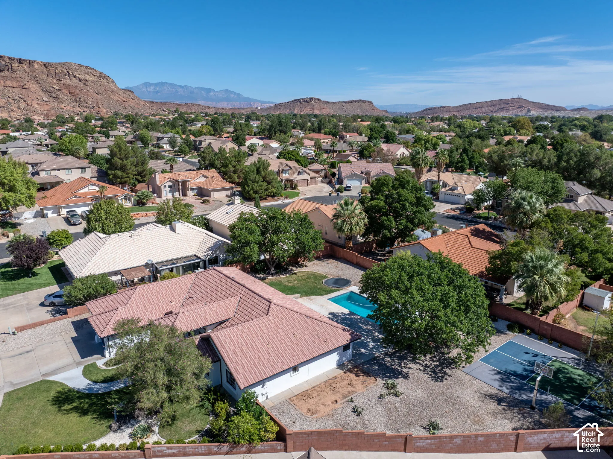 Property featuring a red tile roof, backyard swimming pool, and a dedicated sport court