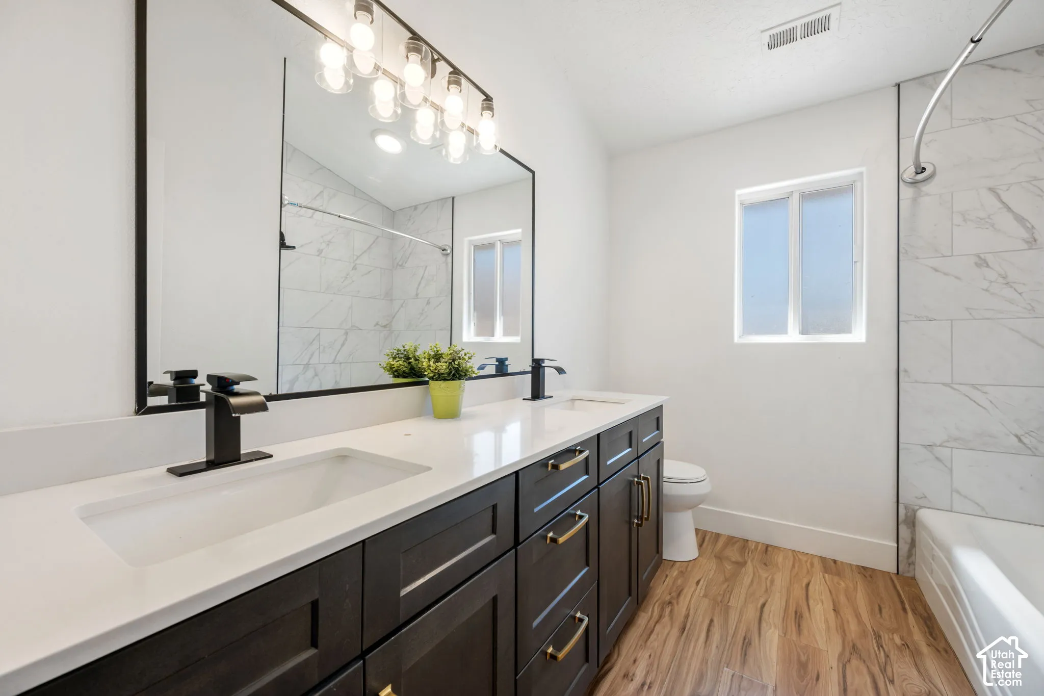 Dual vanity with integrated sinks and black matte faucets