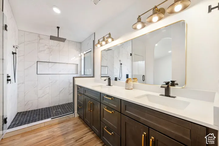 Dual vanity with dark wood-finish cabinetry, gold-tone hardware, and white countertops