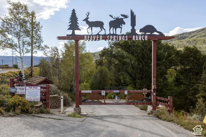 Gated entry featuring a custom metal archway with wildlife silhouettes