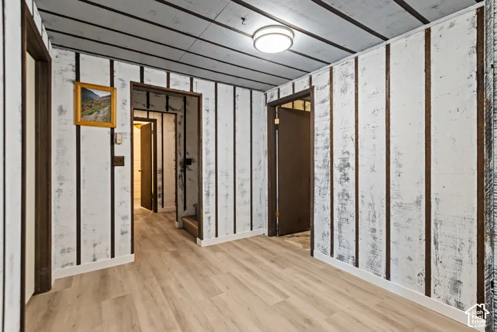 Wood-finish flooring with white baseboards