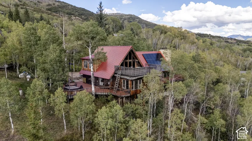 Wood-sided exterior with a red metal roof
