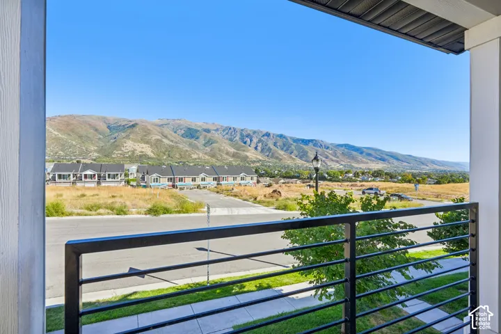 Balcony with metal railing and mountain backdrop