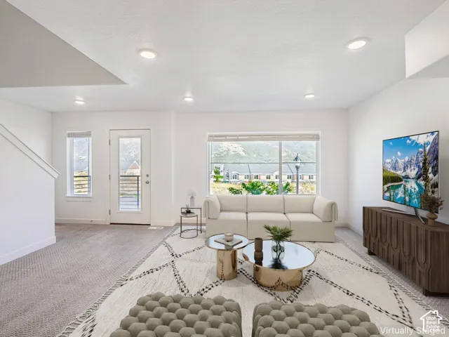 White walls, recessed lighting, carpet flooring, large windows, and a glass-paneled door