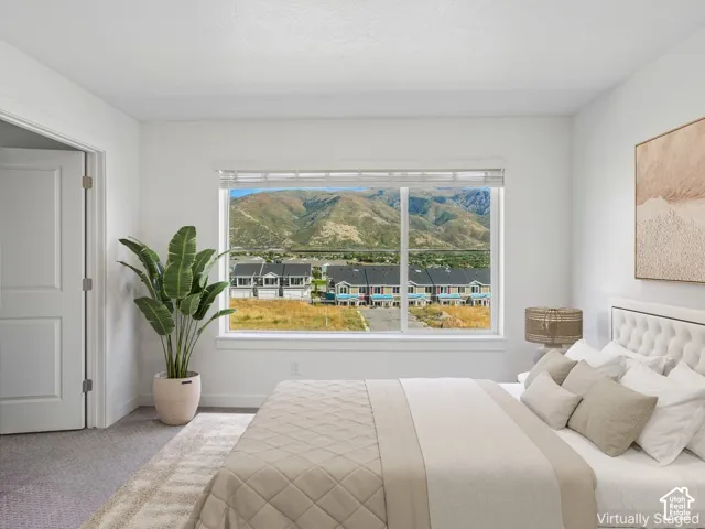 Spacious room with a large window, white trim, and carpeted flooring