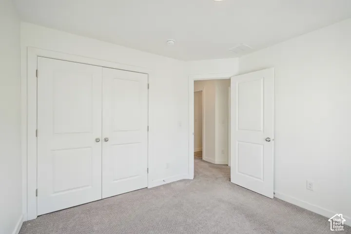 Neutral wall color, carpet flooring, recessed lighting, and solid core doors