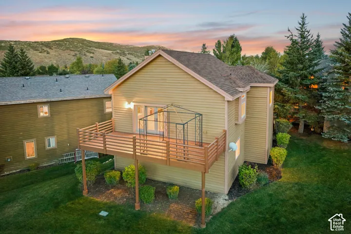 Expansive wood deck with horizontal railing, offering direct access to the interior