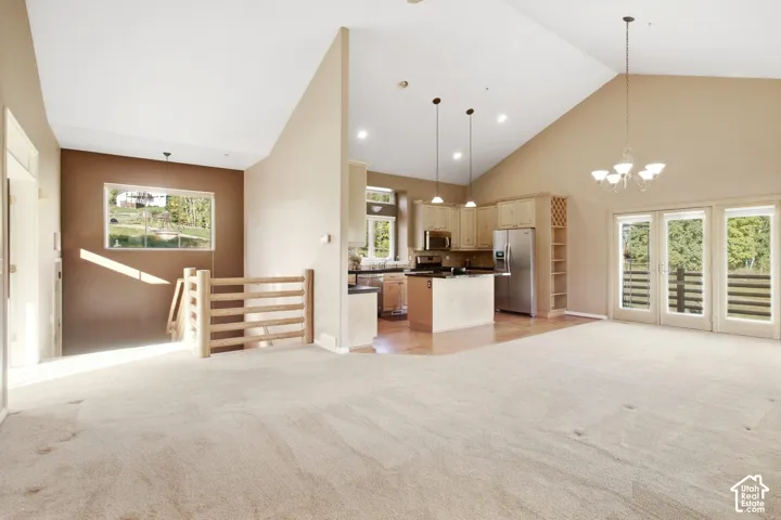 Vaulted ceiling, recessed lighting, wood-finish flooring, stainless steel appliances, and French doors
