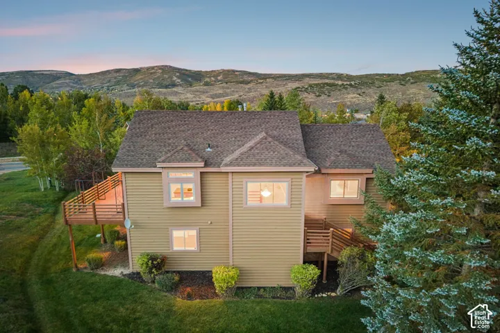 Multi-story residence featuring composite shingle roofing, horizontal siding, and multiple windows