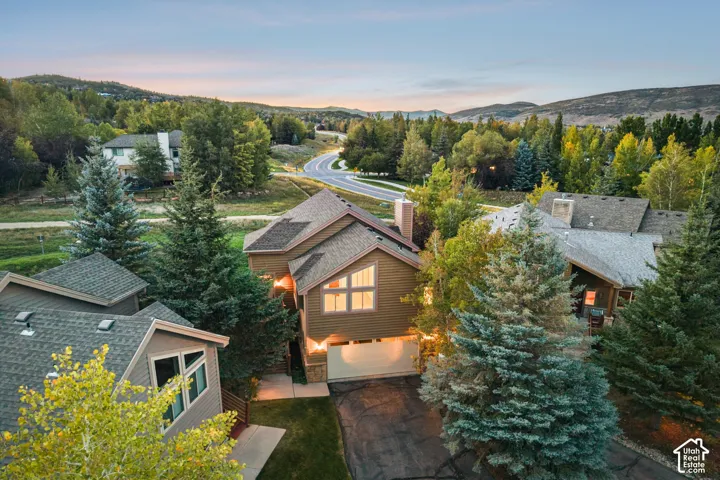 Exterior featuring multi-pitched rooflines, a prominent chimney, and a multi-pane window design