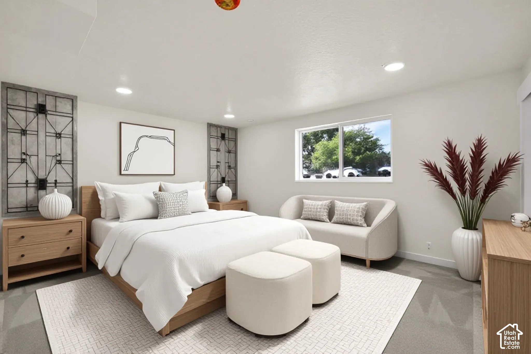 Recessed lighting illuminates the space, featuring a window with exterior views and wood-finish flooring