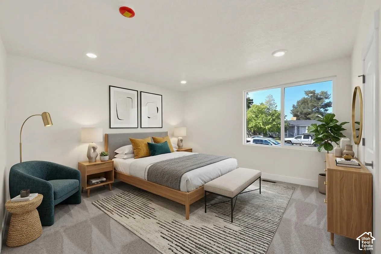 Recessed lighting, large window, neutral wall paint, white trim, and carpeted flooring