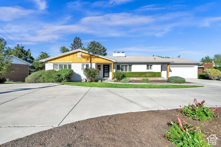 Ranch-style exterior with a wood-accented gable and white facade
