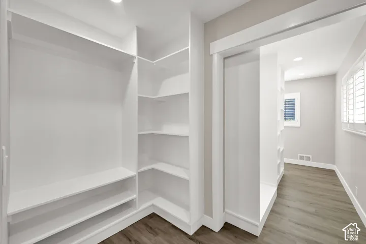 Custom closet system with built-in shelving and hanging rod