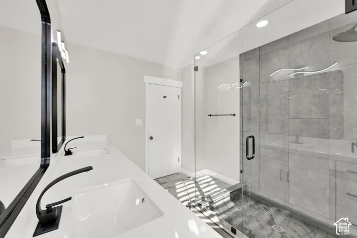 Dual vanity with undermount sinks, matte black faucets, and rectangular framed mirrors